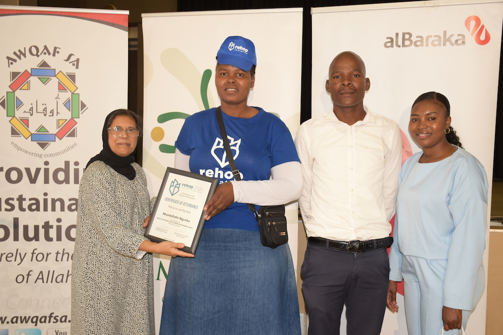 From left to right: Micro Enterprise Development Programme Director, Prof Shahida Cassim, Micro Enterprise Development Programme participant, Ntombifuthi Ngcobo with her brother alongside her and Rehop administrator, Samantha Mthembu.